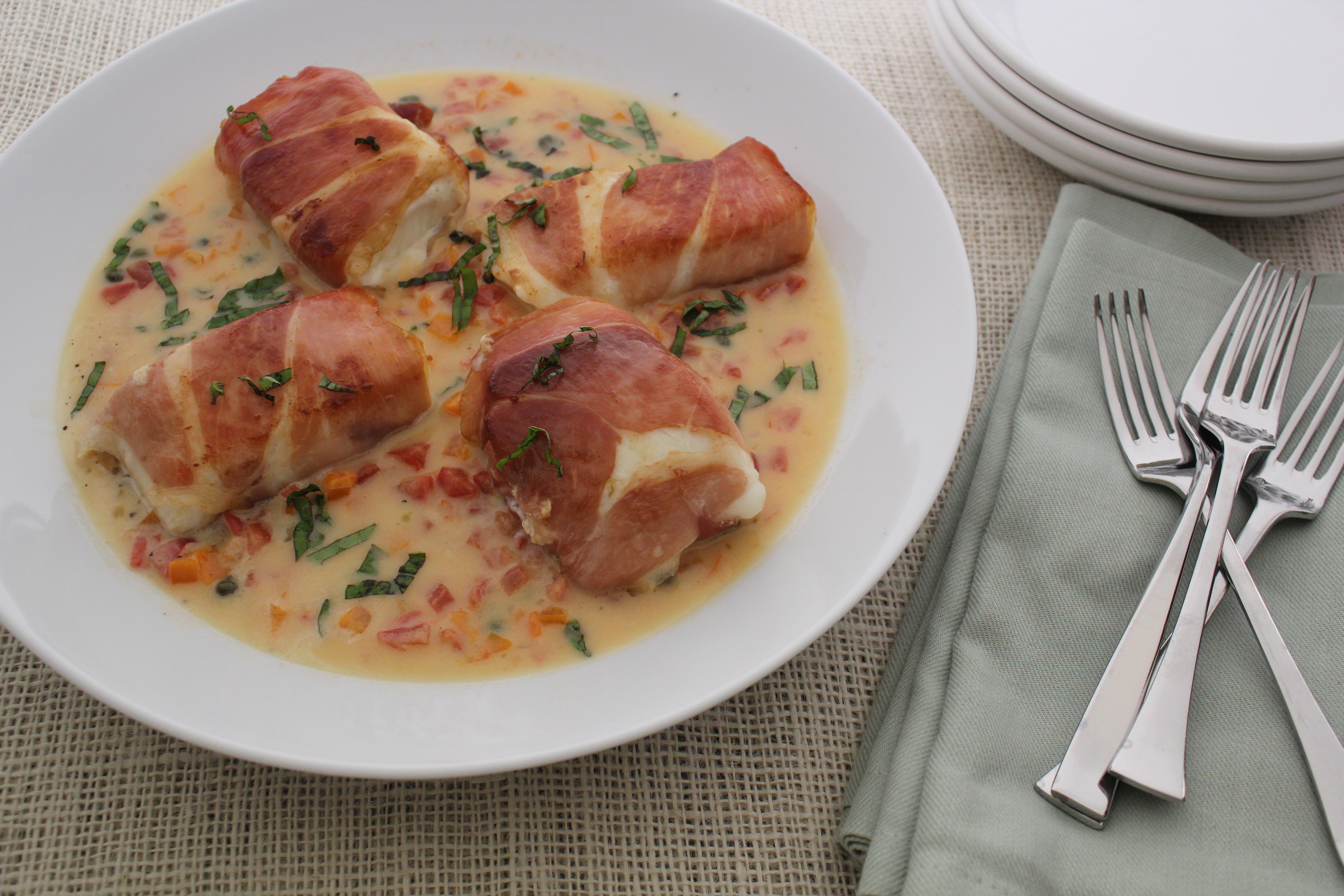 Prosciutto Wrapped Halibut With A Caper And Tomato Butter Sauce | Emerils.com